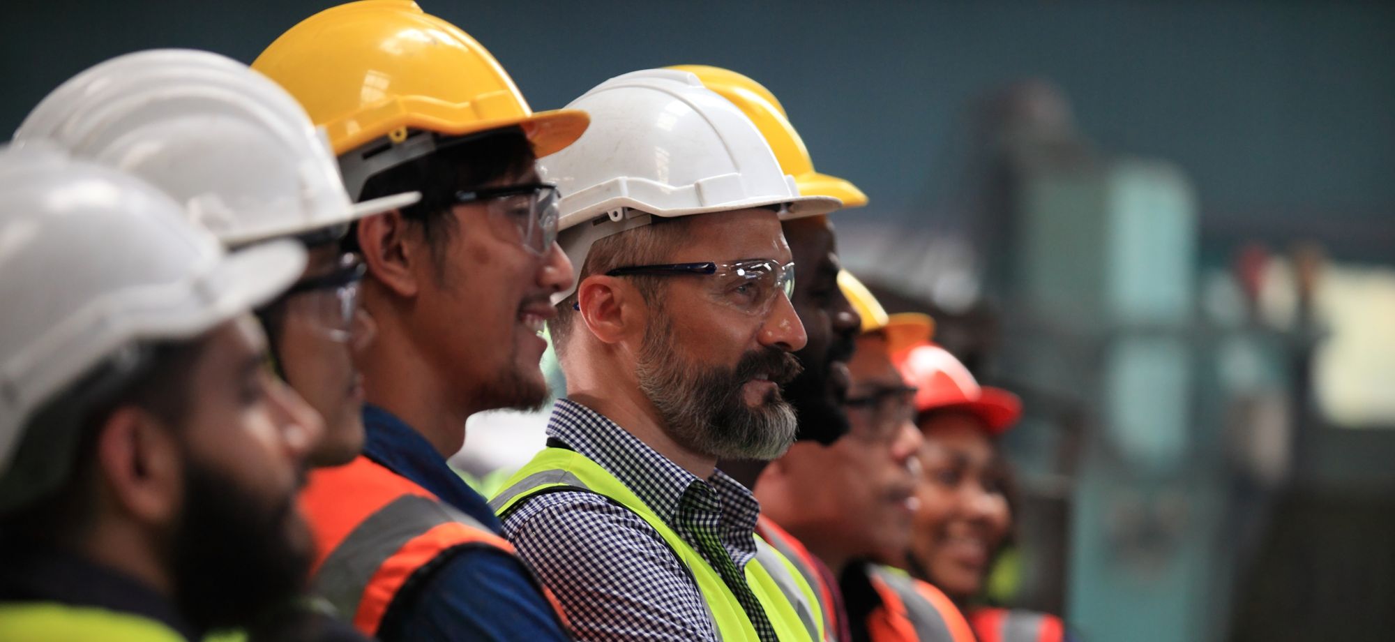 row of male employees wearing PPE