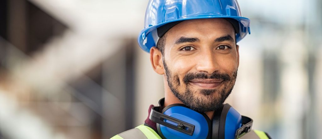 man wearing a blue hard hat and safety vest