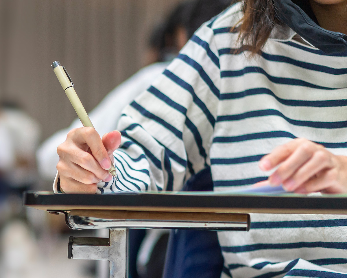 Person sitting at desk writing