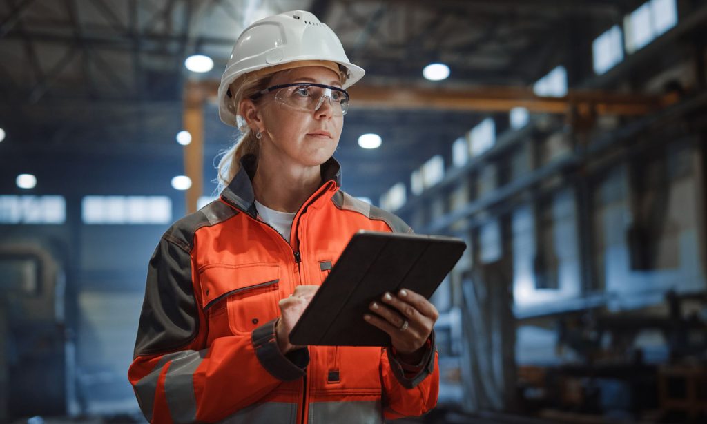 Worker holding a clipboard in a warehouse