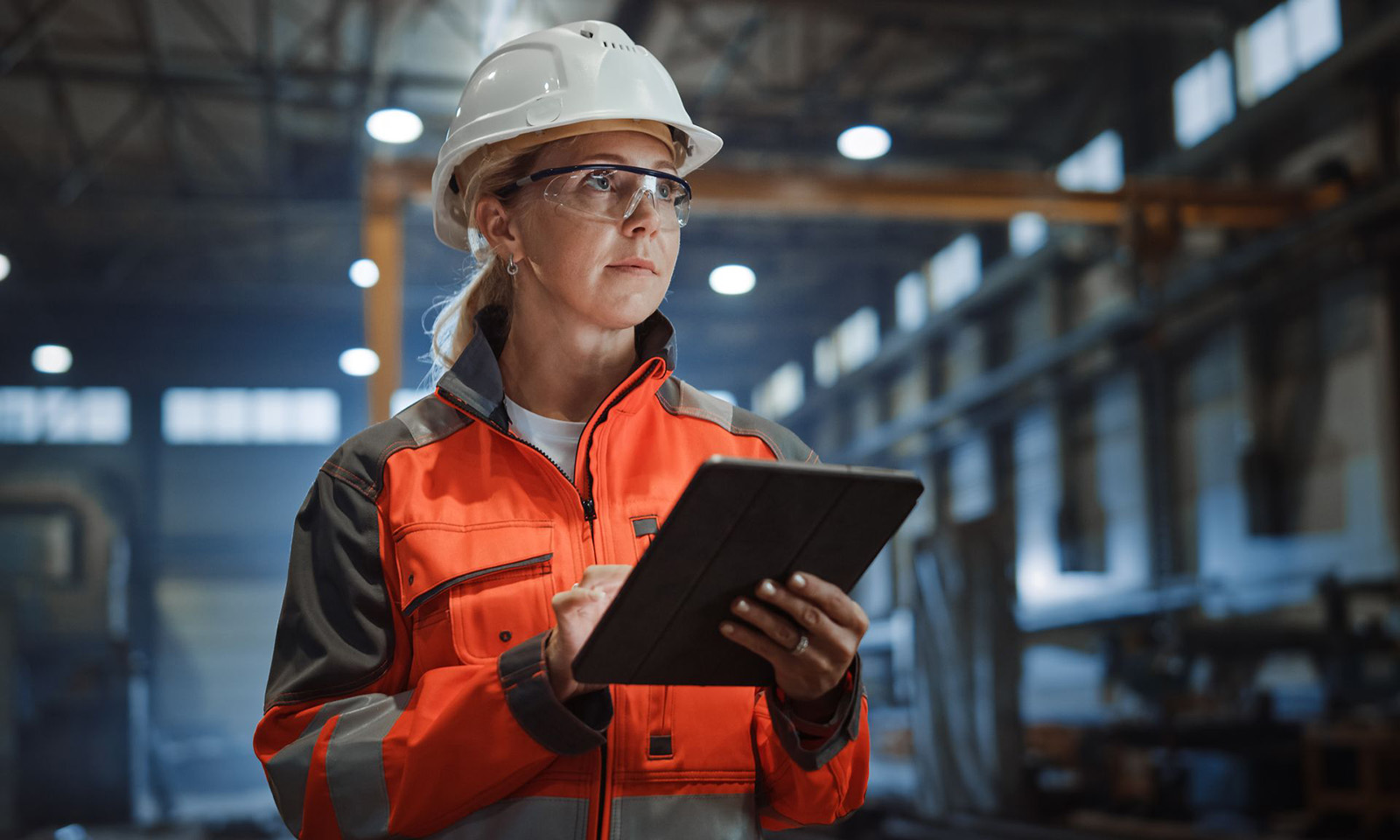 Worker holding a clipboard in a warehouse