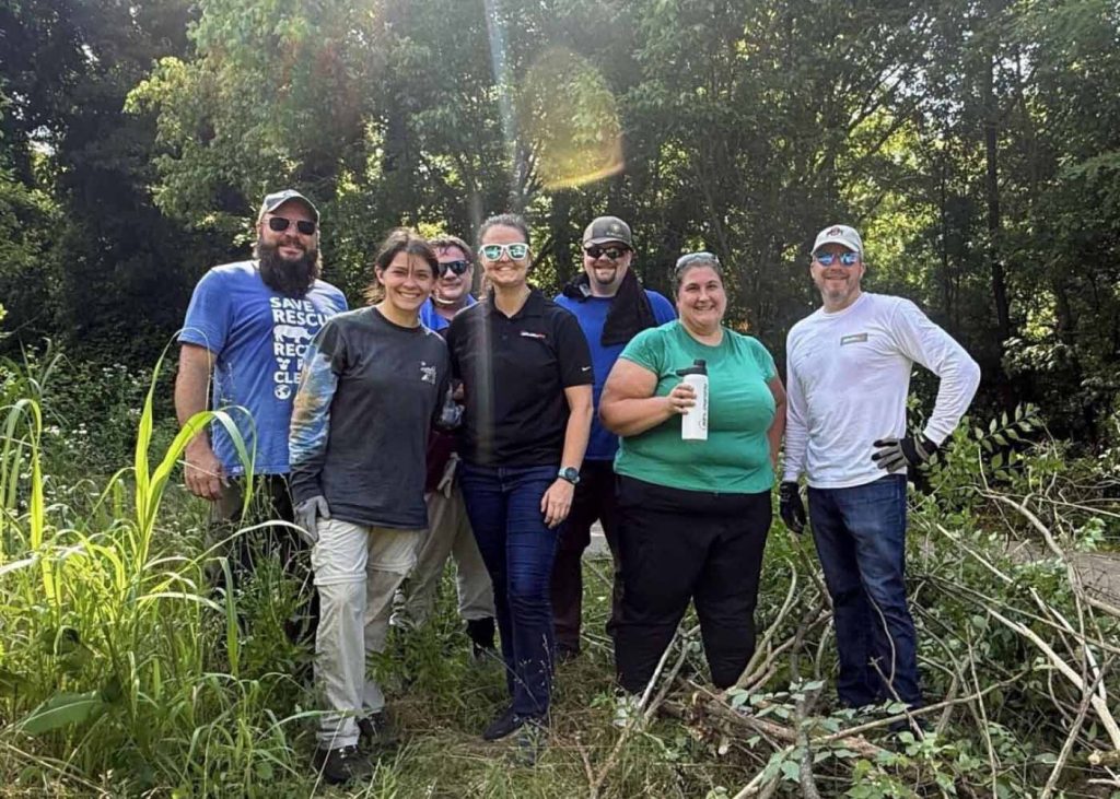 Group photo of SevenGen team members outdoors following volunteer work