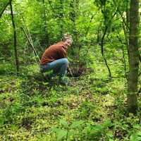 1000088969 Conservation team member working among newly restored native habitat.