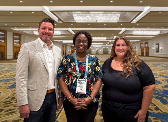 Three people smiling after receiving scholarship